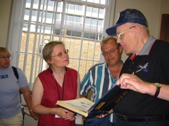 Allen presents a rare 398th book to Susan at HALS library